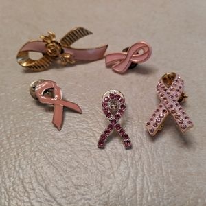 Lot of breast cancer awareness pins.